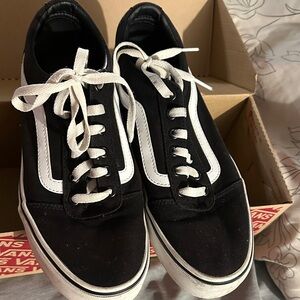 Vans Size Women’s 10 black and White Sneakers Gently worn. Small markings.